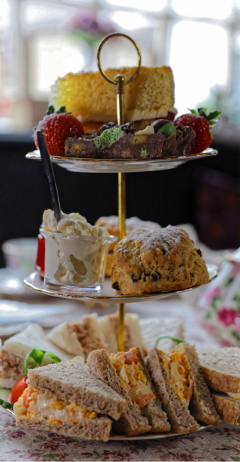 Afternoon tea stand with cakes and sandwiches